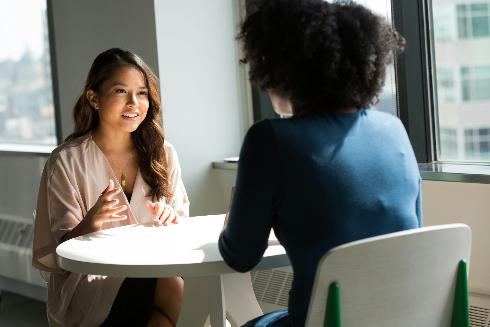 Two women engaged in professional discussion together.