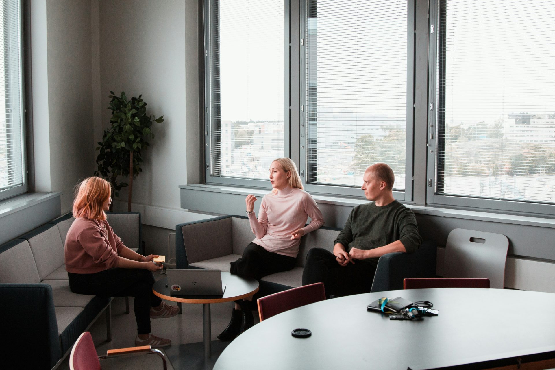 Three colleagues chatting in an office.